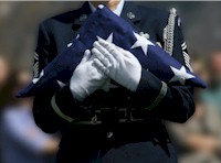 Military Personnel Handing Over American Flag